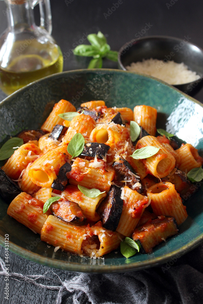 Pasta alla norma - Italian pasta with eggplante, tomato sauce and parmesan cheese on dark table. Top view. Healthy food. Pasta alla norma - Italian pasta with eggplante, tomato sauce and parmesan cheese on dark table. Top view. Healthy food.