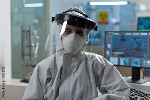 Portrait of scientist woman wearing protective medical equipment against coronavirus working at virus investigation in biochemial hospital laboratory. Researcher virology developing medicine vaccine photo