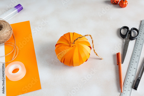 How to make Halloween pumpkin Jack from color paper with children. Step by step tutorial. Handmade DIY holiday decoration project. Step 12.