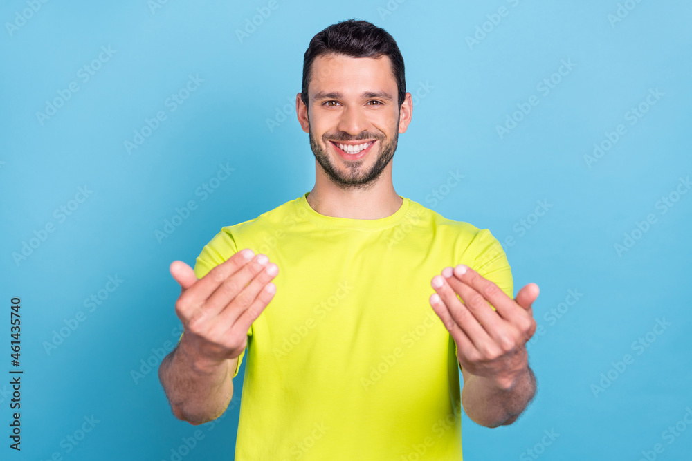 Photo of attractive positive cheerful man come here hands gesture smile enjoy isolated on blue color background Photo of attractive positive cheerful man come here hands gesture smile enjoy isolated on blue color background