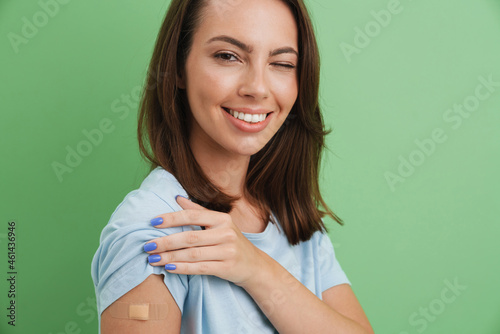 Canvas Young brunette woman winking while showing her bandage