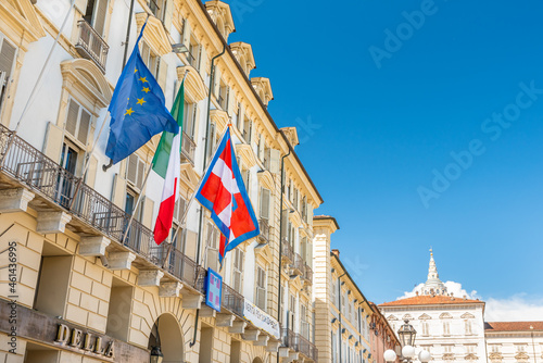 Turin, Italy. May 12, 2021. The flag of Europe, Italy and the Piedmont Region flutters on the facade of the historic building seat of the Government of the Piedmont Region in Piazza Castello.