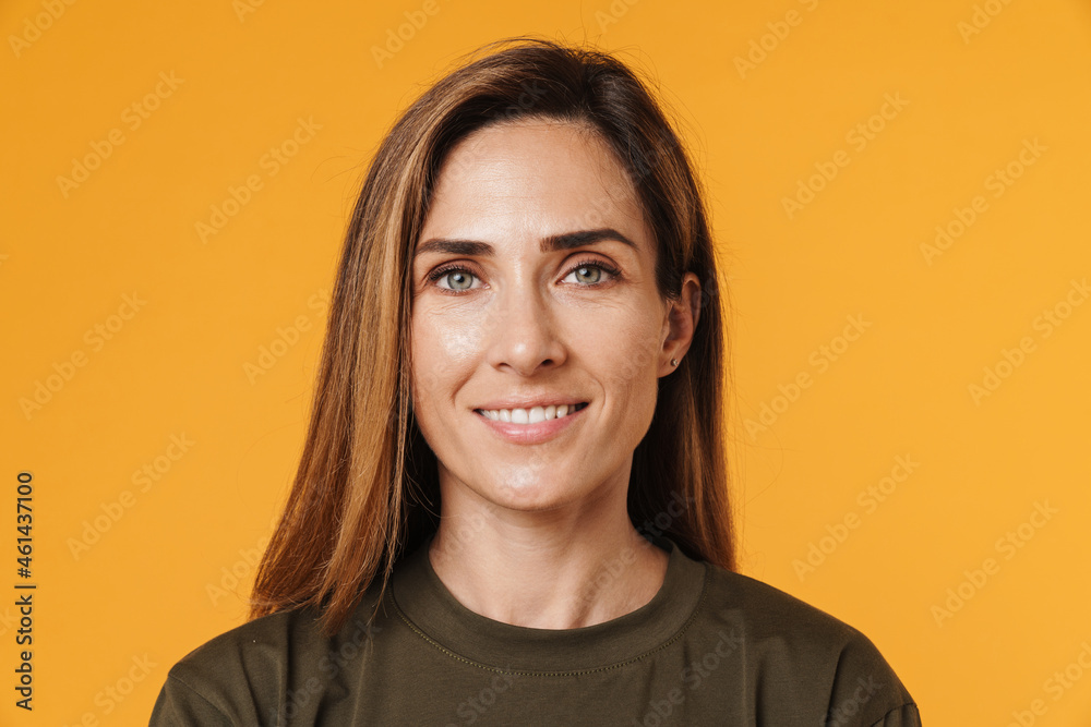 European ginger woman in t-shirt smiling while looking at camera European ginger woman in t-shirt smiling while looking at camera