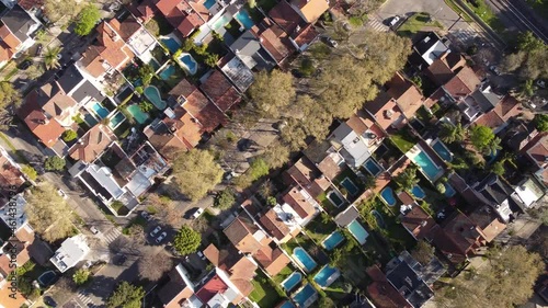 Aerial top down view of residential Houses with swimming pools in Vicente López. DSrone flying over luxury homes with garden and swimming pools. photo