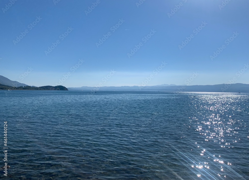 Blue surface of the lake, blue sky, azure lake background