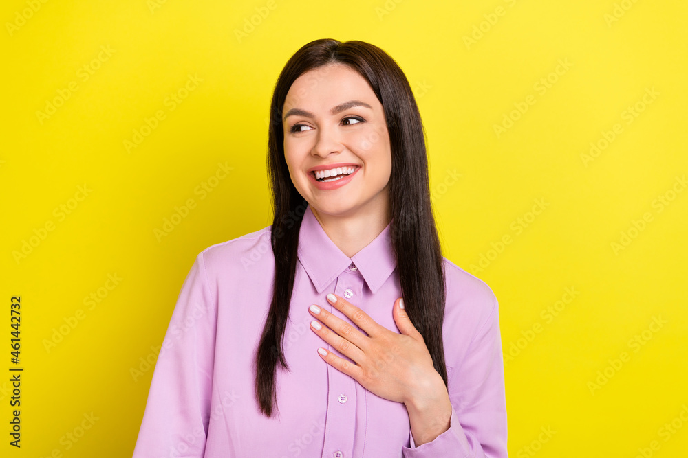 Photo of lovely brown hairdo young lady hand heart look empty space wear purple shirt isolated on yellow color background Photo of lovely brown hairdo young lady hand heart look empty space wear purple shirt isolated on yellow color background