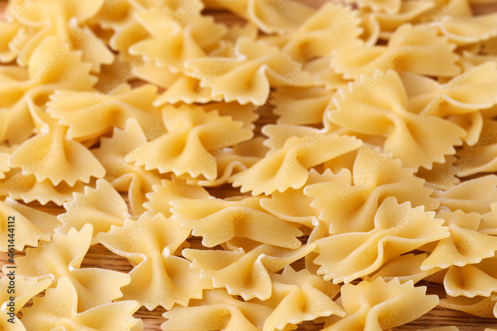 Authentic pasta background in the form of bows. Close-up. Selective focus Authentic pasta background in the form of bows. Close-up. Selective focus