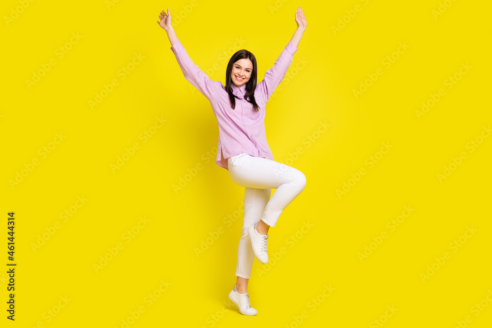 Full length body size view of attractive cheerful girl rejoicing having fun isolated over bright yellow color background