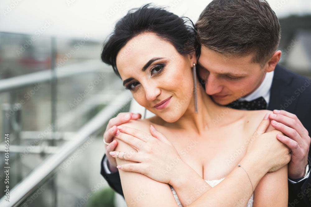 Romantic wedding moment, couple of newlyweds smiling portrait, bride and groom hugging Romantic wedding moment, couple of newlyweds smiling portrait, bride and groom hugging