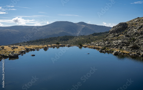 Beautiful lake with mountains in backgfround. The location is Laguna Grande of Peñalara in Madrid