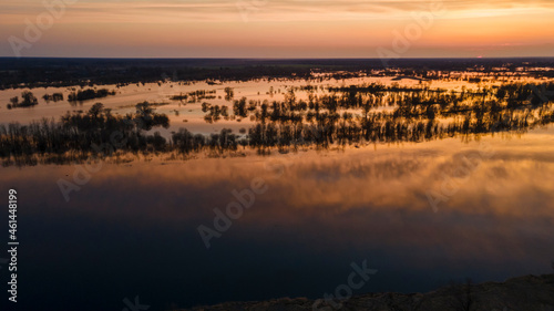 Aerial atmospheric view on big river. Aerial drone view of river landscape in sunny sunset. Nature concept.