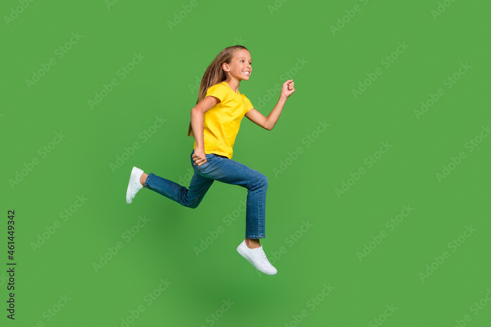 Full length body size view of attractive cheerful girl jumping running active life isolated over bright green color background