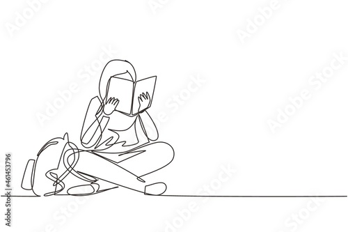 Single continuous line drawing happy young woman reading book sitting on floor. Smart female reader enjoying literature or studying and preparing for exam. One line draw design vector illustration photo