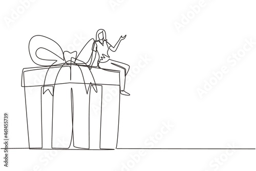Single continuous line drawing businesswoman sitting on big gift box. Big present concept. Female sitting on big box with present. Happy person gets huge gift. One line draw design vector illustration