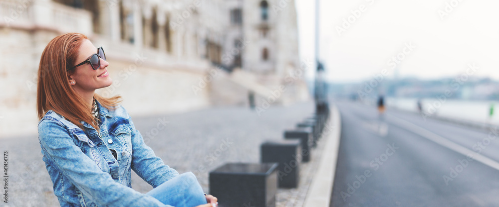 Fototapeta premium Young redhead hungarian woman relaxing at Parliament building, Budapest, Hungary