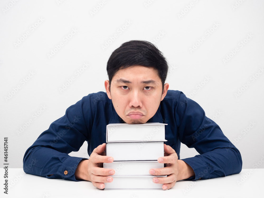 Man gesture feeling bored about reading the books on the table white background Man gesture feeling bored about reading the books on the table white background