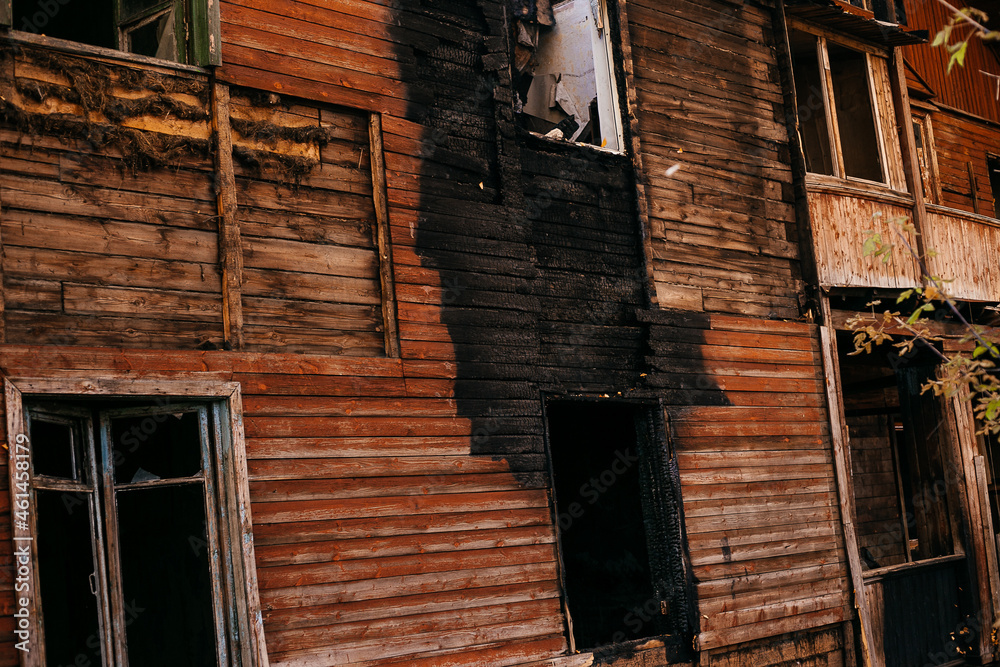 Old wooden two-storey house without windows after a fire Old wooden two-storey house without windows after a fire