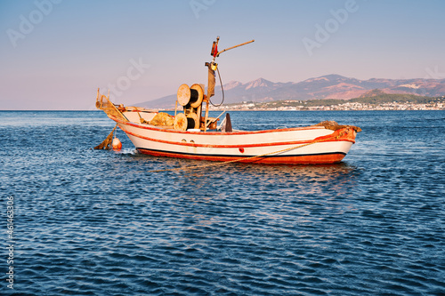 Old traditional fishing boat or trawler anchored on the sea.
