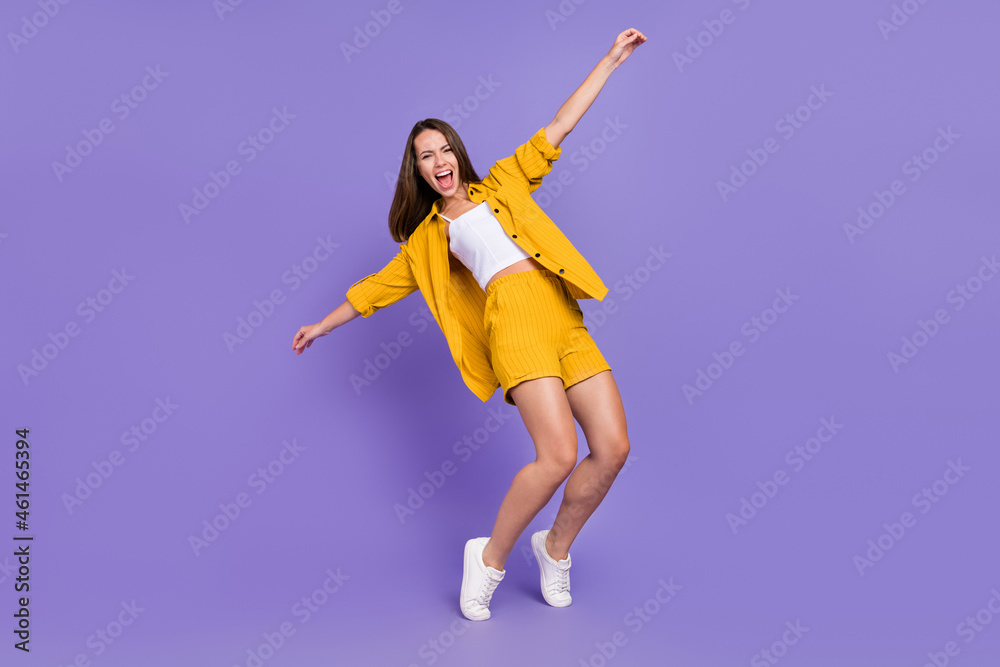 Full size photo of funny young brunette lady dance wear yellow outfit sneakers isolated on purple background