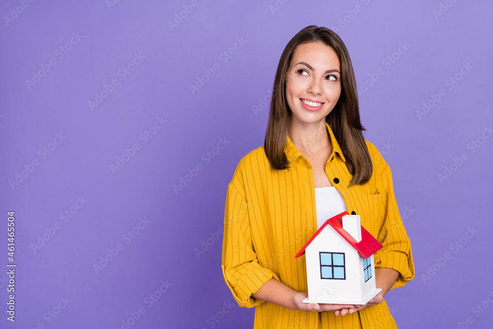 Photo of cute millennial brunette lady sell flat wear yellow shirt isolated on purple background Photo of cute millennial brunette lady sell flat wear yellow shirt isolated on purple background