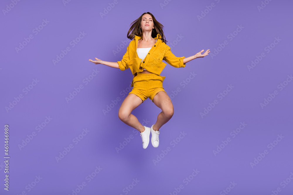 Full size photo of rest millennial lady jump wear yellow suit sneakers isolated on violet background