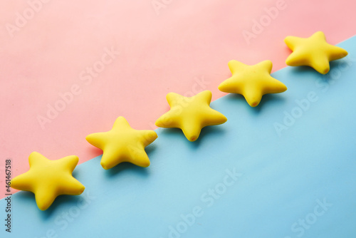 Customer review concept. Rating golden stars on blue background 