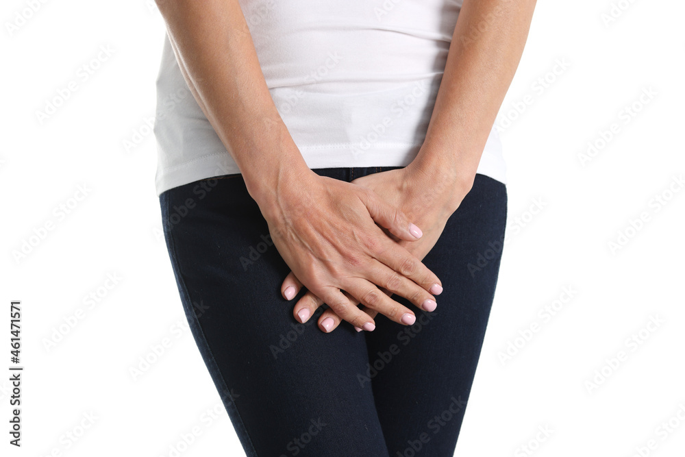 Young sick woman holds hands pressing to perineum to lower abdomen