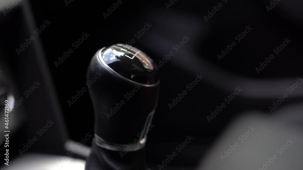 Man driver changing gears with manual transmission gear stick, close up
