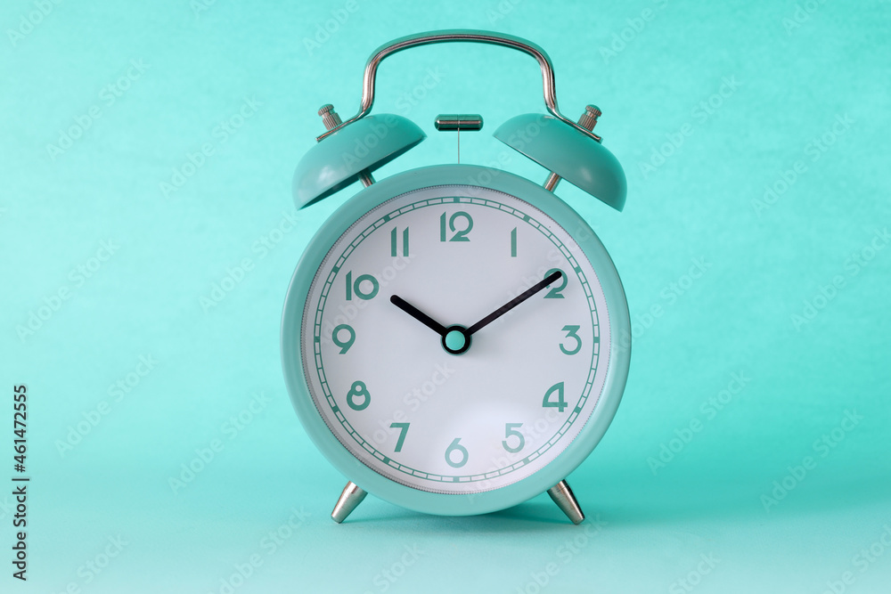 Turquoise classic alarm clock at ten in morning on mint background Photos |  Adobe Stock