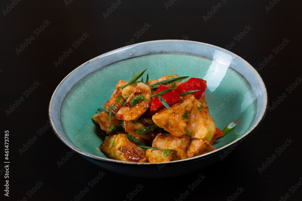 Salad with fried zucchini on a black background Salad with fried zucchini on a black background