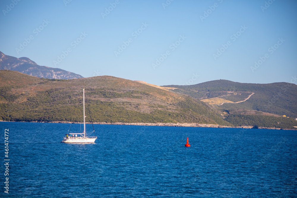 View of small yacht boat sailing in calm open sea in Montenegro 