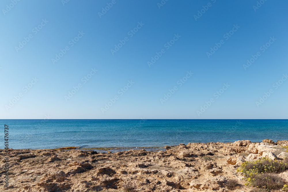 Beautiful seascape. Travel concept. Seascape on the background of the wild rocky coast. Wild beach, azure water and rocks. Luxury summer adventure, Mediterranean sea, Cyprus. Postcard view