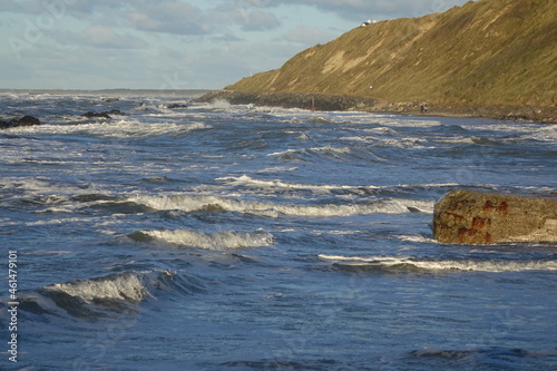 Hiking the coastal path of Lonstrup on a sunny and stormy day, Jammerbugt, Lonstrup, Hjorring, Northern Jutland, Denmark
