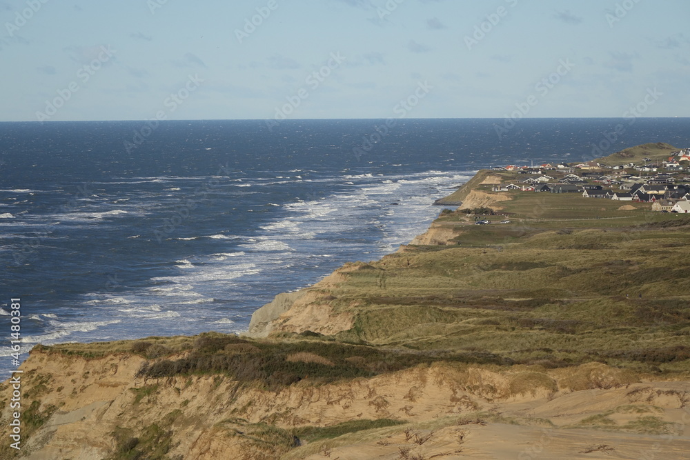 Scenic view from famous Rubjerg Knude Fyr Lighthouse to the north over the North Sea and Lonstrup on a sunny day, Jammerbugt, Lonstrup, Hjorring, Northern Jutland, Denmark

