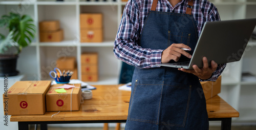Starting small businesses SME owners man entrepreneurs working, box and check online orders to prepare to pack the boxes, sell to customers, sme business ideas online.