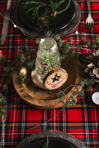 Christmas table setting with wreath and wooden ornaments photo