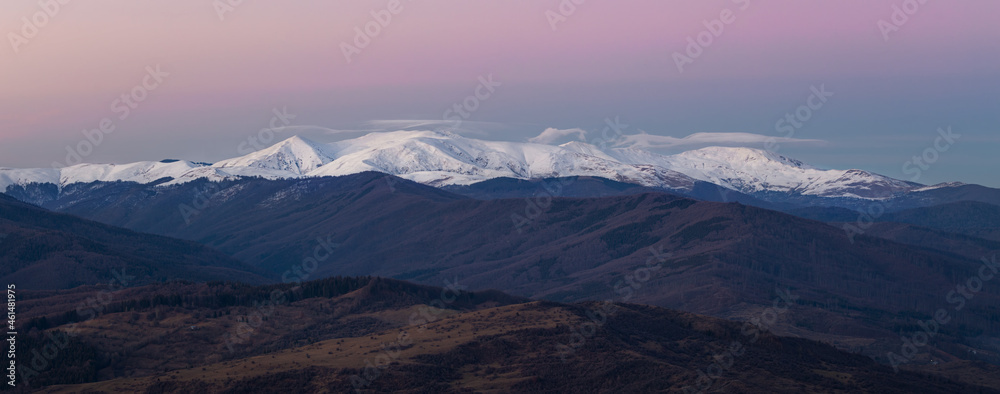 Far away - snowy mountains at sunset