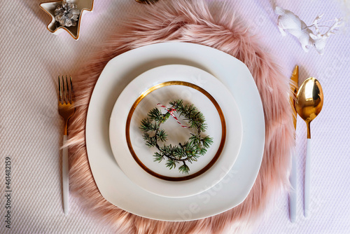 Pink christmas table setting with white and gold decorations photo