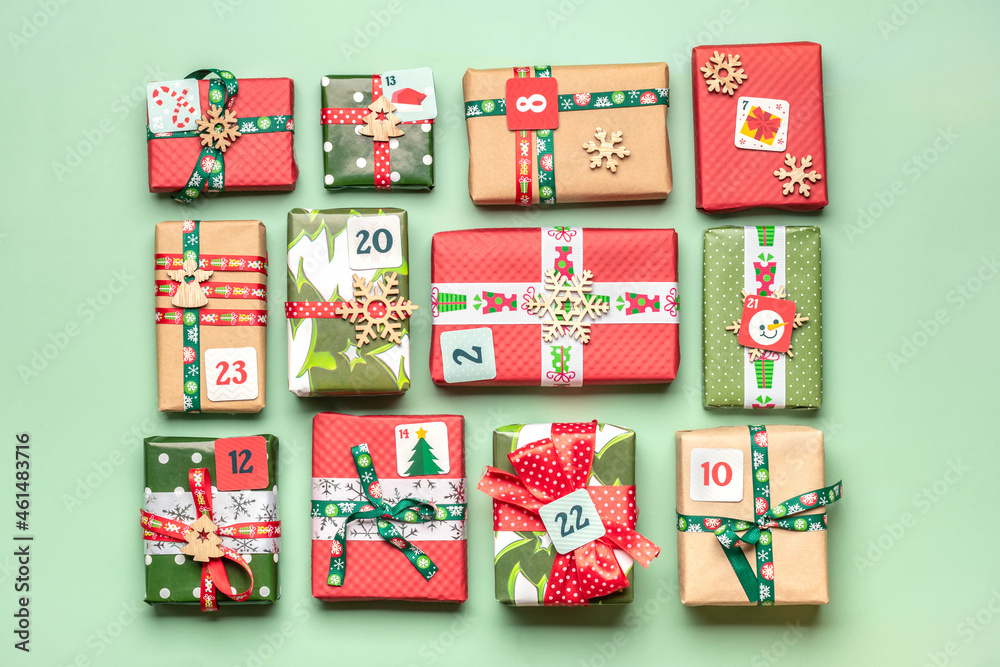 Handmade wrapped red, green gift boxes decorated with ribbons, snowflakes and numbers, Christmas decorations and decor on green table Xmas advent calendar concept Top view Flat lay Holiday card Handmade wrapped red, green gift boxes decorated with ribbons, snowflakes and numbers, Christmas decorations and decor on green table Xmas advent calendar concept Top view Flat lay Holiday card