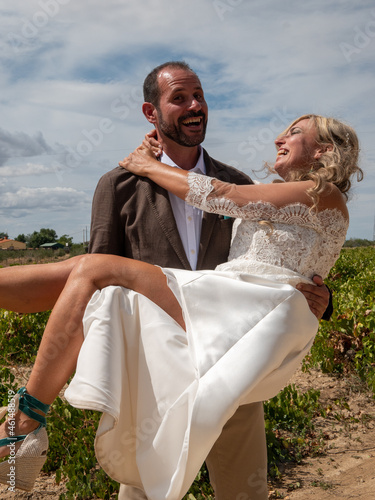 Happy Spanish couple hugging during the wedding ceremony photo