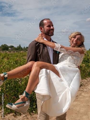 Happy Spanish couple hugging during the wedding ceremony photo