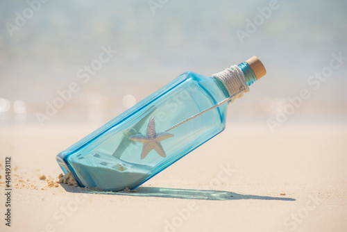 Blue glass bottle still life on a tropical beach paradise