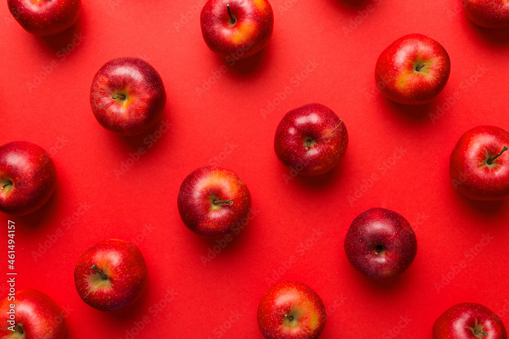 Many red apples on colored background, top view. Autumn pattern with fresh apple above view Many red apples on colored background, top view. Autumn pattern with fresh apple above view