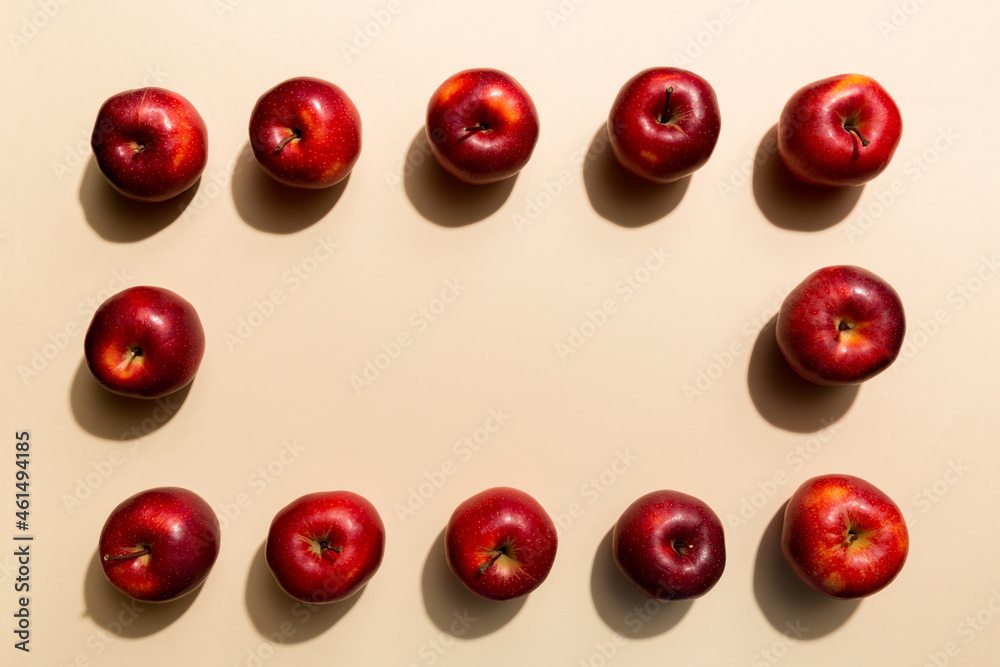 Many red apples on colored background, top view. Autumn pattern with fresh apple above view