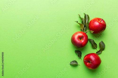 Many red apples on colored background, top view. Autumn pattern with fresh apple above view with copy space for design or text
