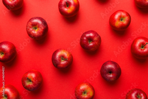 Many red apples on colored background, top view. Autumn pattern with fresh apple above view