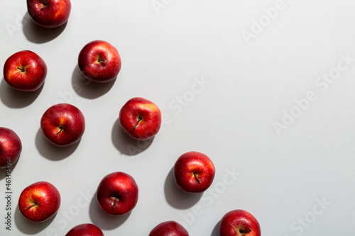 Many red apples on colored background, top view. Autumn pattern with fresh apple above view with copy space for design or text
