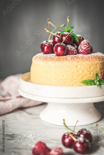 A homemade Japanesse souffle cheesecake served with fresh cherries photo