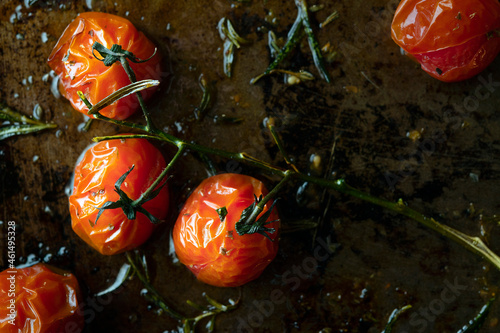 Vine ripened tomatoes roasted on a baking tray.