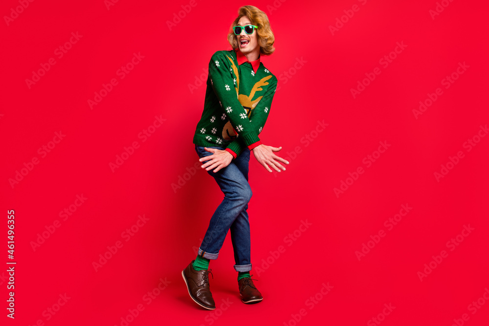 Full length body size view of attractive funky cheerful guy dancing having fun fooling isolated over bright red color background Full length body size view of attractive funky cheerful guy dancing having fun fooling isolated over bright red color background